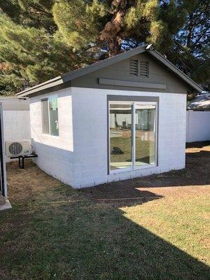 Finished Shed to office conversion with AC, two custom sliding windows, and glass sliding door