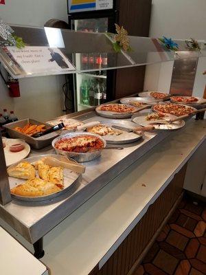 The buffet which is maintained with fresh hot pizza.