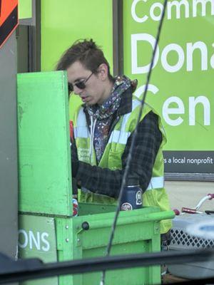 The employee breaking donated items.