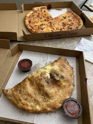 12" Philly Cheese Steak Calzone in front. 16" large sausage pizza.