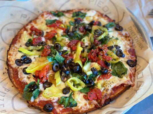 Custom Pie: Gluten Free dough with black olives, red and banana peppers, spinach, and pineapples