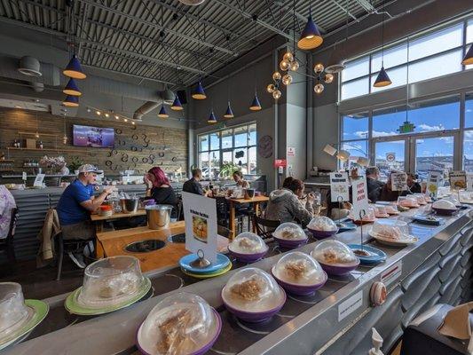 Conveyor belt with hot pot ingredient options and inside of restaurant