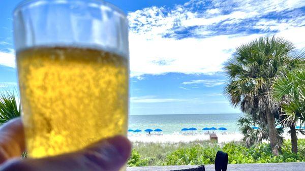 Glass of Ice cold Stella beer overlooking the Gulf of Mexico.