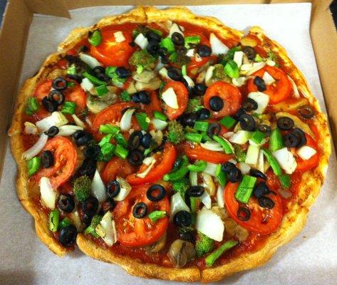 veggie pizza without cheese. Onions, Green Peppers, Mushrooms, Black Olives, Tomatoes, Broccoli, and Artichoke