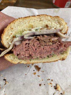 Delicious roast beef sandwich. Not too much of the fixings., just provolone, onions, mayo, and their sauce.