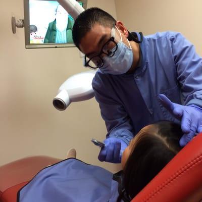 Dr. Teramura taking dental x-rays while Zoe watches Sofia the First.