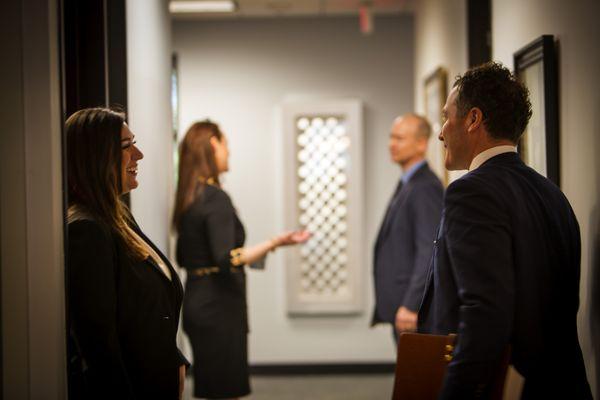 Attorneys and staff enjoying a brief moment of conversation during the workday. Communication is key to achieving successful case outcomes.