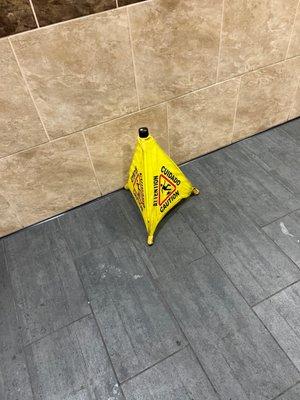 Wet floor sign with no wet floor, probably been there for hours