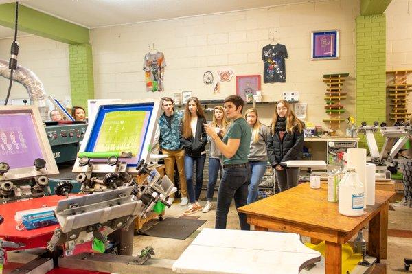 Hosting workshops and field trips to teach the art of screen printing