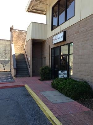 Door to business. Tucked away in the back lot when you pull in.