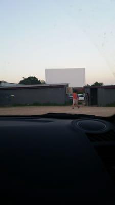 Half the movie screen cut off by the buildings in the back spots.