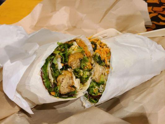 Peanut chicken burrito. Mock chicken, fresh greens cabbage, carrots, green onions and crushed peanuts, sweet house peanut vinaigrette