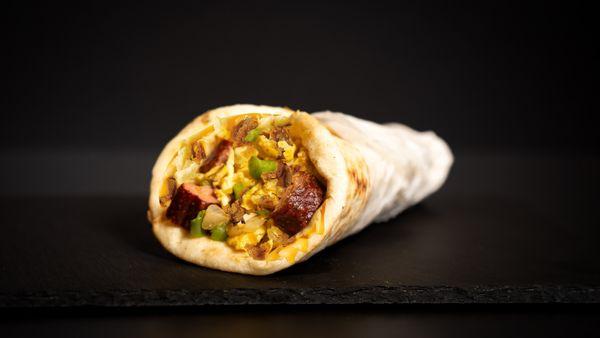 Breakfast Gyro: A warm pita filled with fluffy scrambled eggs, onions, green peppers, melted cheese & halal turkey sausage.