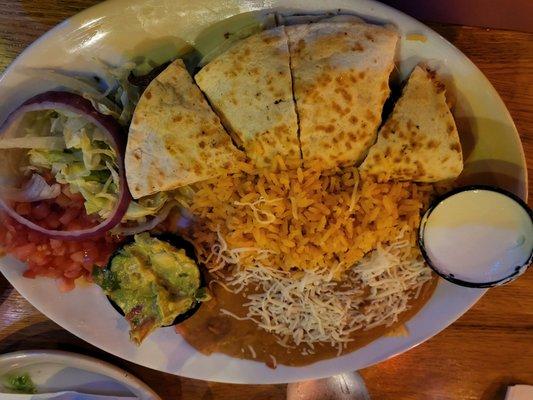 Steak quesadilla with a side of rice and beans