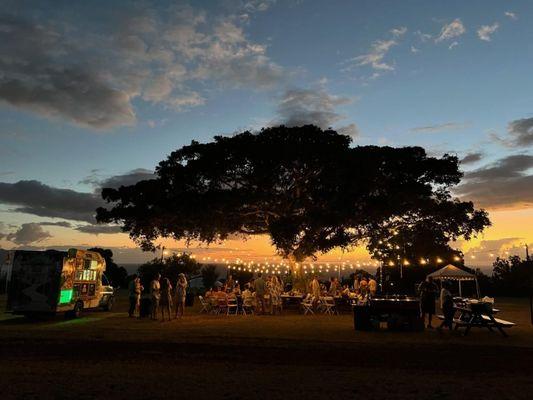 Kona Ice truck all aglow on the left.