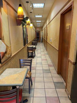 Seating along hallway inside Subway, and all the tables are clean!