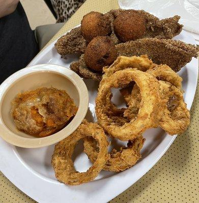 Catfish, onion rings, sweet potato casserole, and hush puppies.