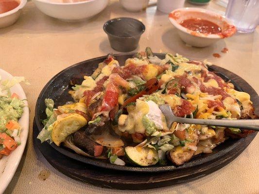 Combo fajitas after I mixed queso, guac, salsa, and lettuce. This plate was really good. Skipped the beans, rice and tortillas.