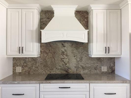 White Valley ganite kitchen with full height backsplash.