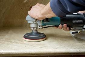 Grinding stone surfaces to eliminate stains and even out surface