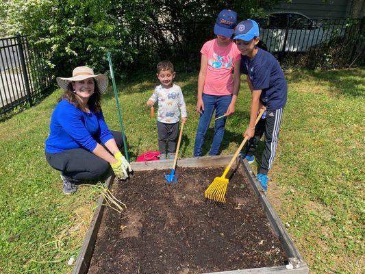 Stars students working on their family plot in our community garden