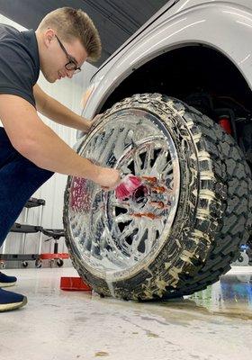 This is a wheel being cleaned during an exterior detail