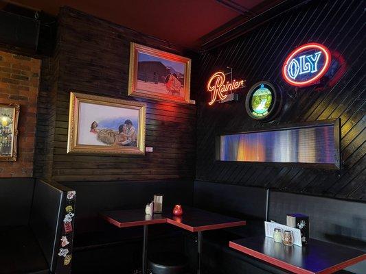 Corner tables with neon and art