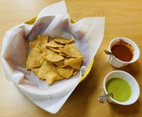 Complimentary tortilla chips with homemade hot sauces.