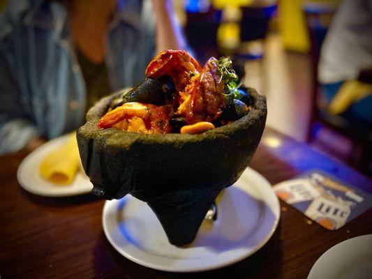 Seafood Molcajete served in sizzling hot rock tureen - "dinner and a show"! Highly recommend