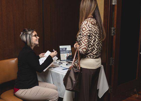 Guests checking into one of our monthly educational dinner presentations.