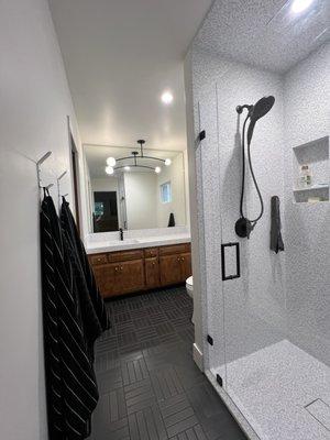 Completed bathroom remodel with Staron solid surface in Dalmatian Mosaic