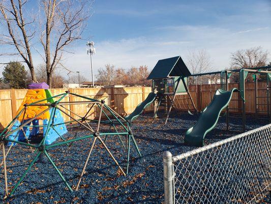 Our Outside Playground for our friends who are 3 years old and older. It is complete with rubber bark, climbing structures, swings, & slides