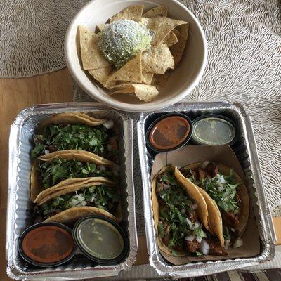 Guacamole and chips, carne asada and chipotle chicken with their green and red sauce