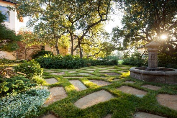 Custom cut sod around flagstone for the perfect fountain courtyard.