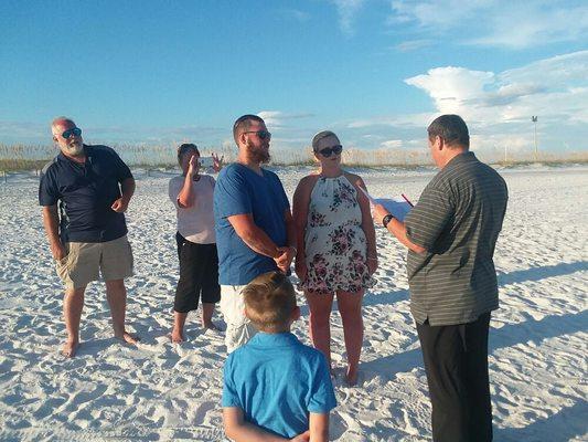 Rev. Tom officiating at wedding ceremony at Penscola Beach, Florida.