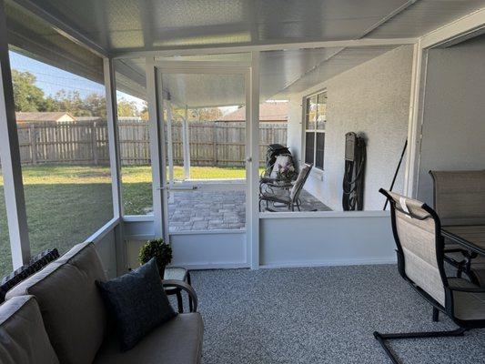 View of inside screened room looking out to outside covered patio.