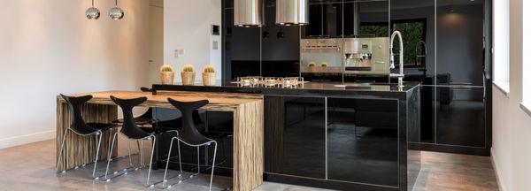 In N Out Remodeling added a luxurious island to this black kitchen, creating a focal point in the open concept space.