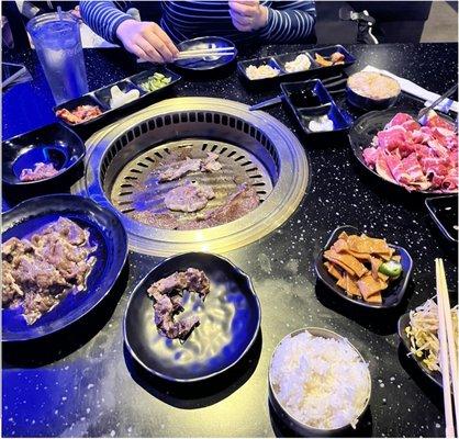 We ordered several meats, fried rice, steamed rice, fish cakes, bean sprouts, kimchi, pickled salad, tempura vegetables, and fried chicken.