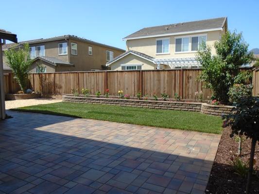 Calstone Pavers with Wet Look sealant, stone wall, sod,plants with drip irrigation.