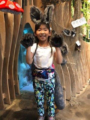 A student posing as a wolf, outside the bear cave.