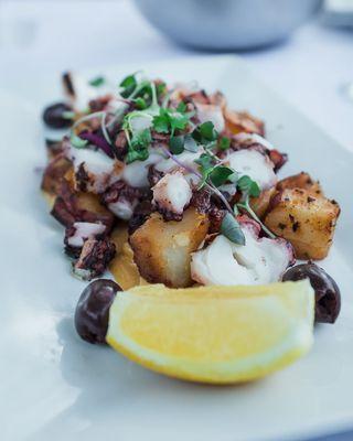 Perfectly cooked octopus over portatoes