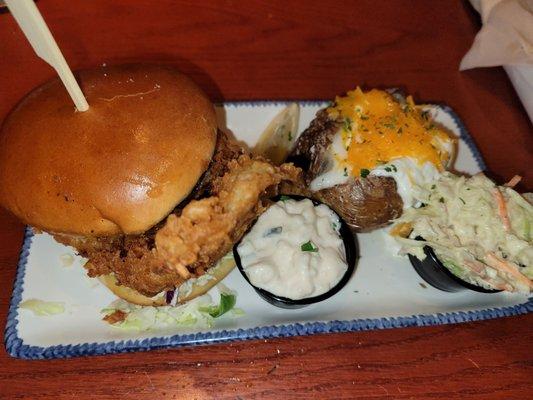 Cod sandwich with baked potato and coleslaw