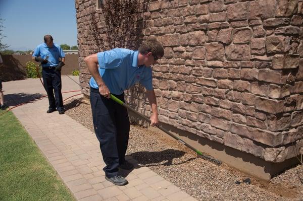 Techs treating home to prevent termite damage.