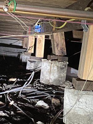 Failing structural system under home supporting floors