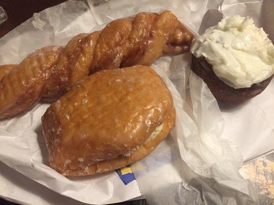 Orange twist (top left), Bavarian creme (front) and pumpkin donut with cream cheese.