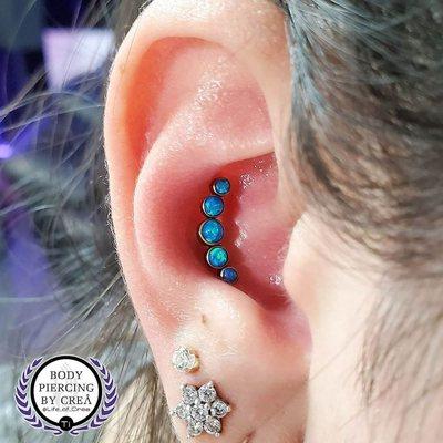 Daith piercing with titanium opal cluster. Body Piercing by Crea