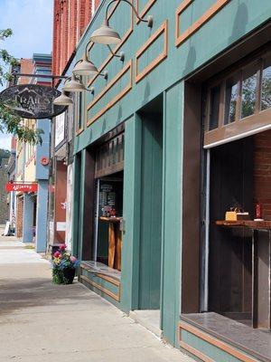 Out front, cool garage type doors that open up onto the sidewalk out front. Best combination of eating inside yet outside.