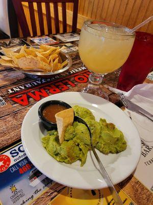 Chips and guacamole with a margarita.