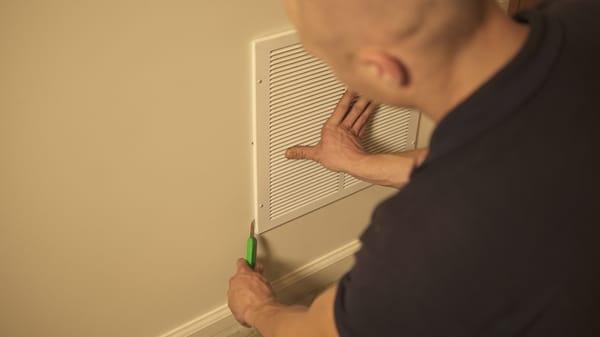 Gently cutting around intake vent grill, not to damage the paint when removing the grill.