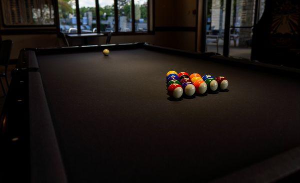 The pool table located in the downstairs clubhouse